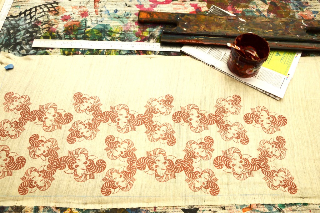 Screen printing the patterns on silk fabric